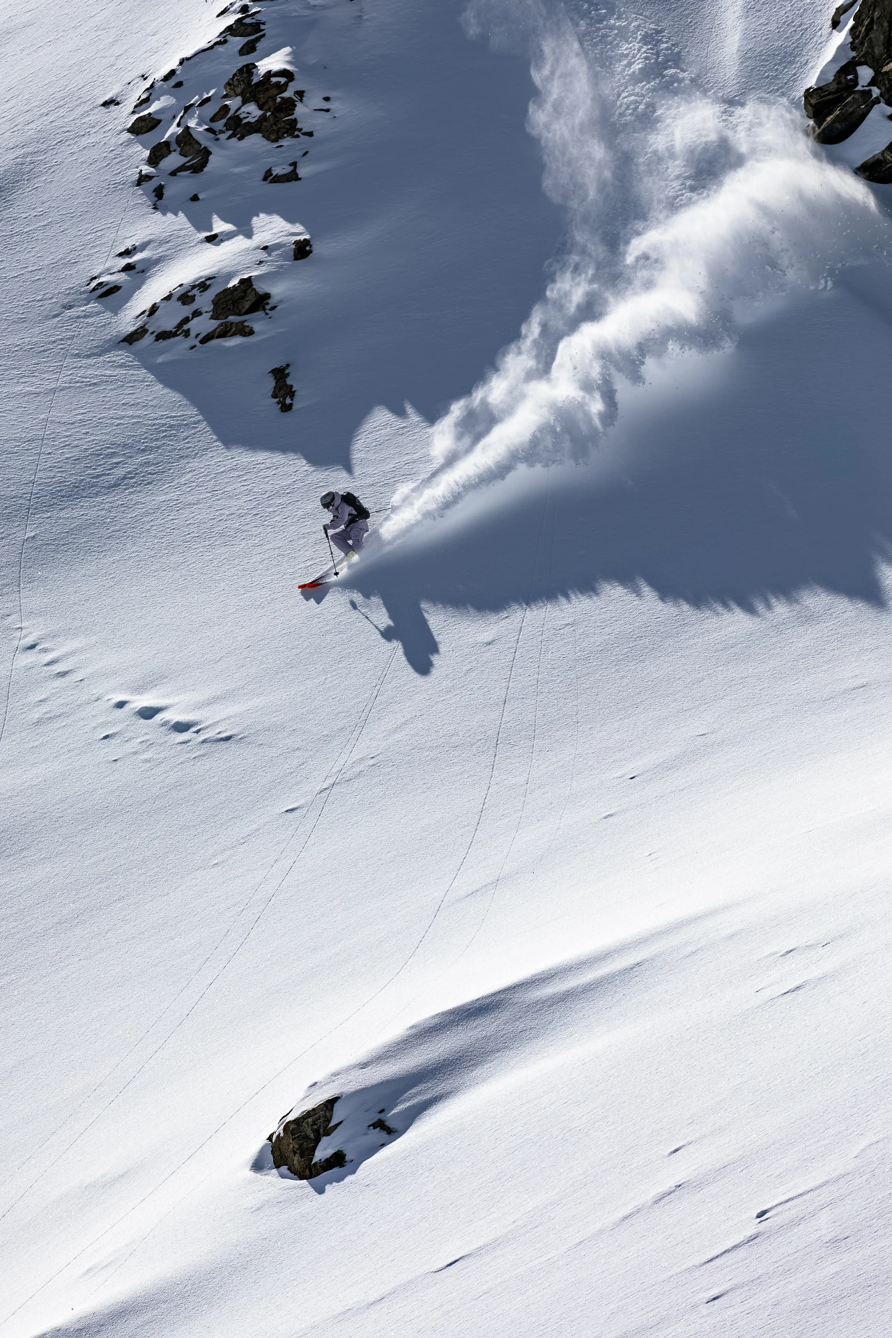 Andrea Limbacher carving a powder turn on a slope in Lenzerheide